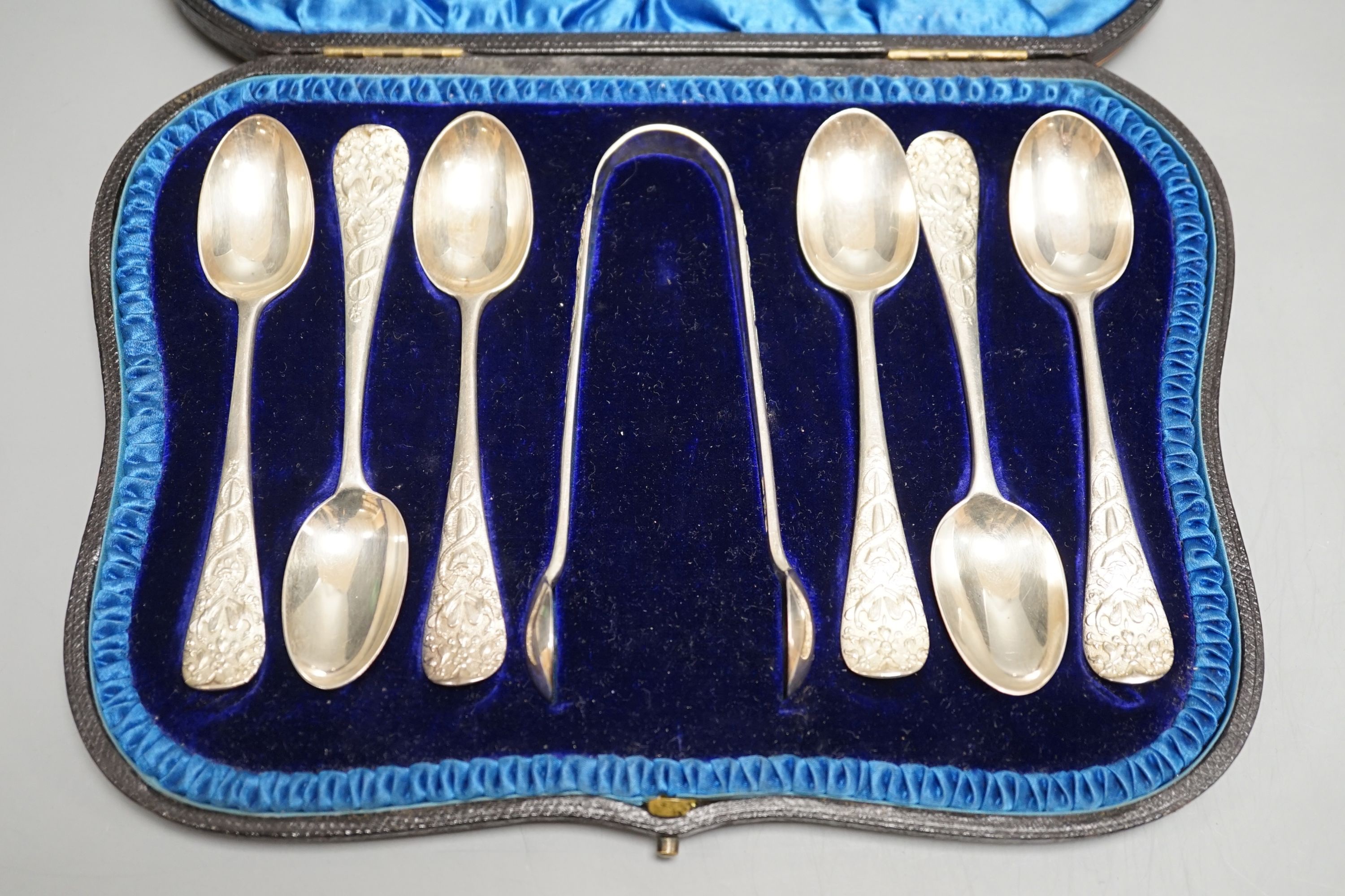 A cased set of six late Victorian silver teaspoons with sugar tongs, London, 1898.